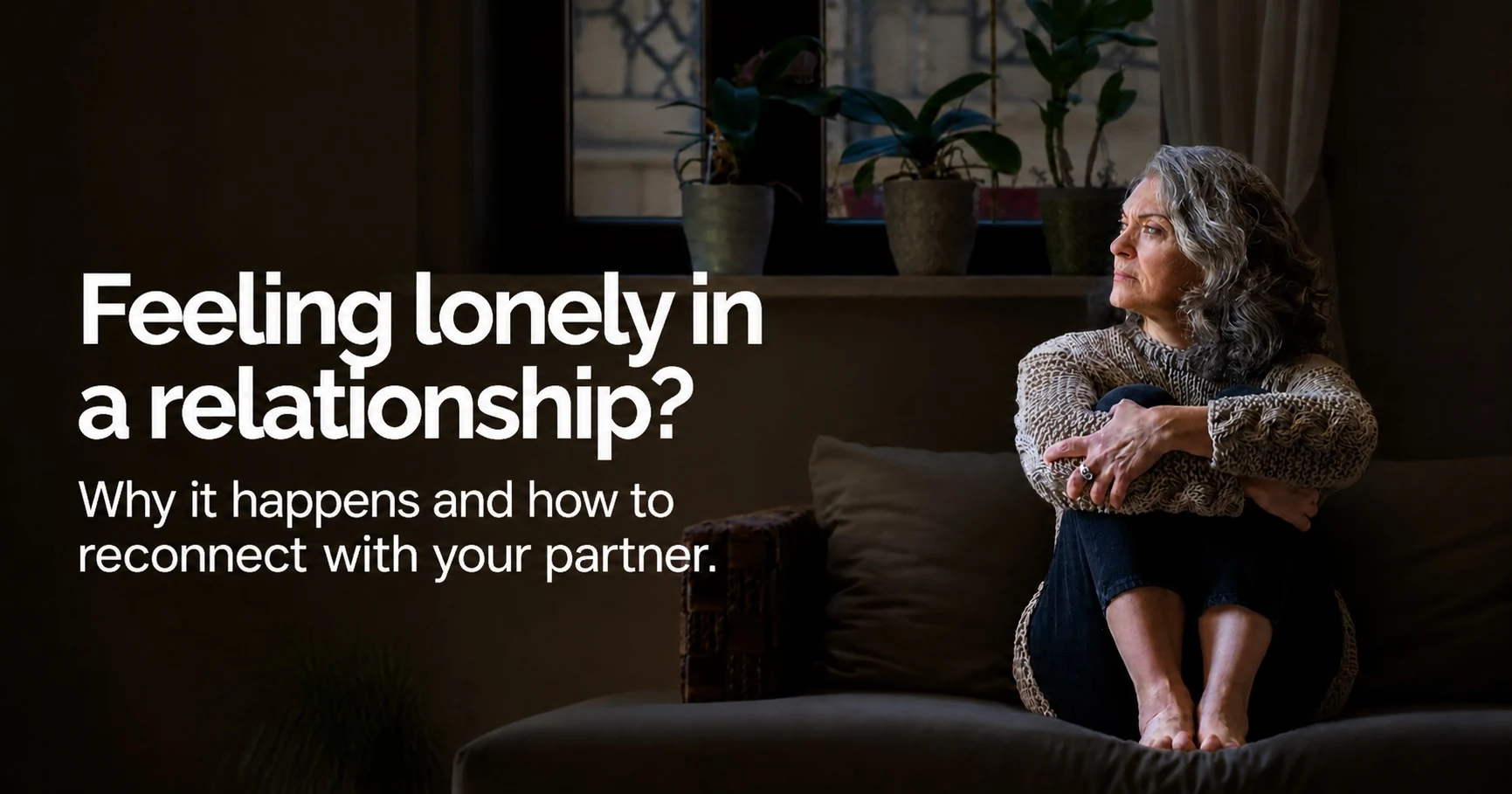 A woman sits alone on a sofa with her arms wrapped around her knees, looking away toward a window in a dimly lit room, beside the headline Feeling lonely in a relationship? Why it happens and how to reconnect with your partner. A woman sits alone on a sofa with her arms wrapped around her knees, looking away toward a window in a dimly lit room, beside the headline Feeling lonely in a relationship? Why it happens and how to reconnect with your partner.